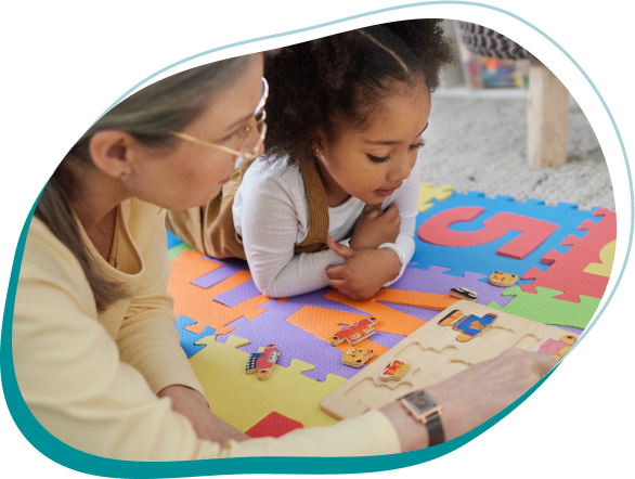 a person and a child playing with puzzle
