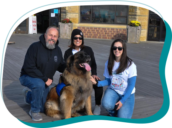 a group of people posing with a dog