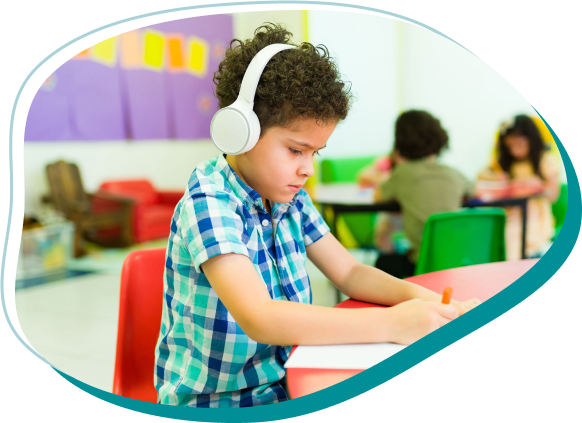 a child wearing headphones sitting at a desk