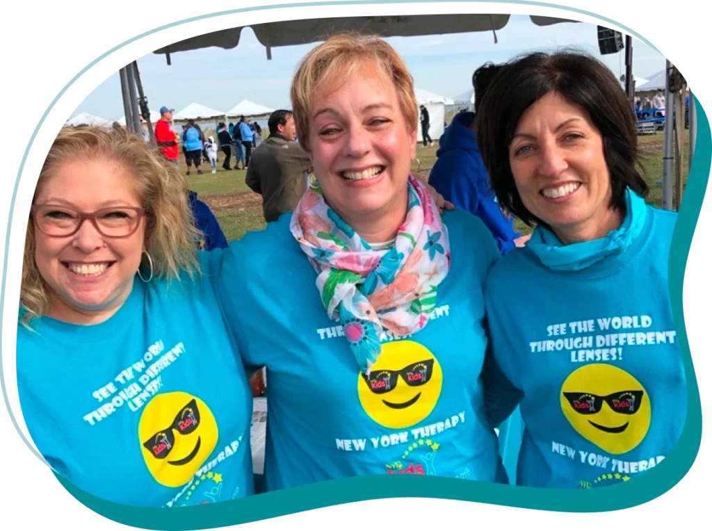 Three smiling women wearing NYTPS shirts