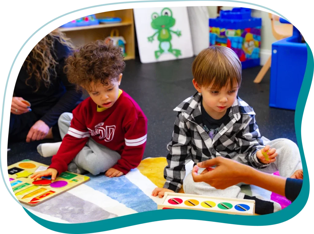 Two preschool children playing on the floor
