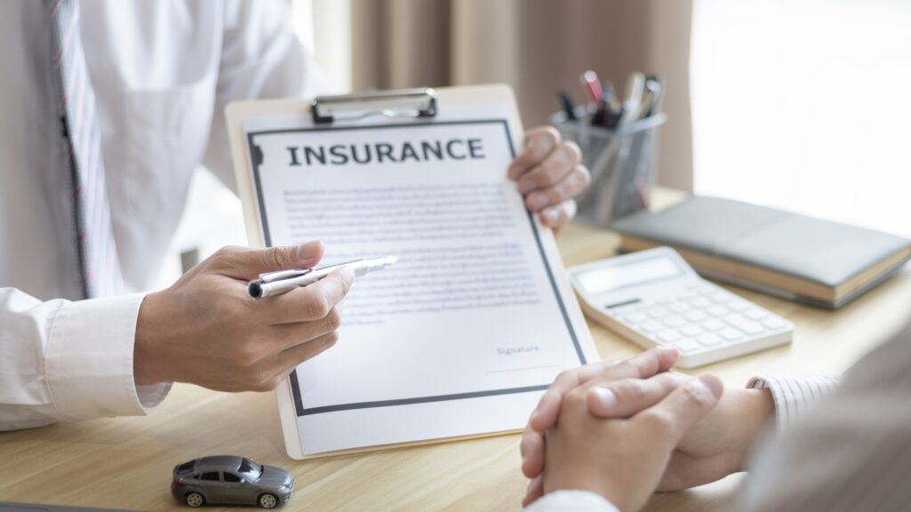 therapist holding up insurance information for aba therapy