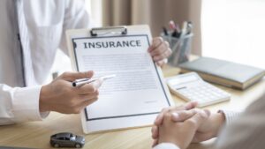 therapist holding up insurance information for aba therapy