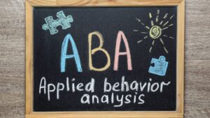 a chalkboard that says aba applied behavior analysis with puzzle pieces on it